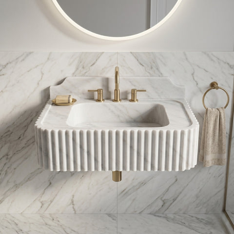 Carrara White marble basin with a wide top ledge, deep bowl, and decorative ribbing wrapping around the front and side edges.