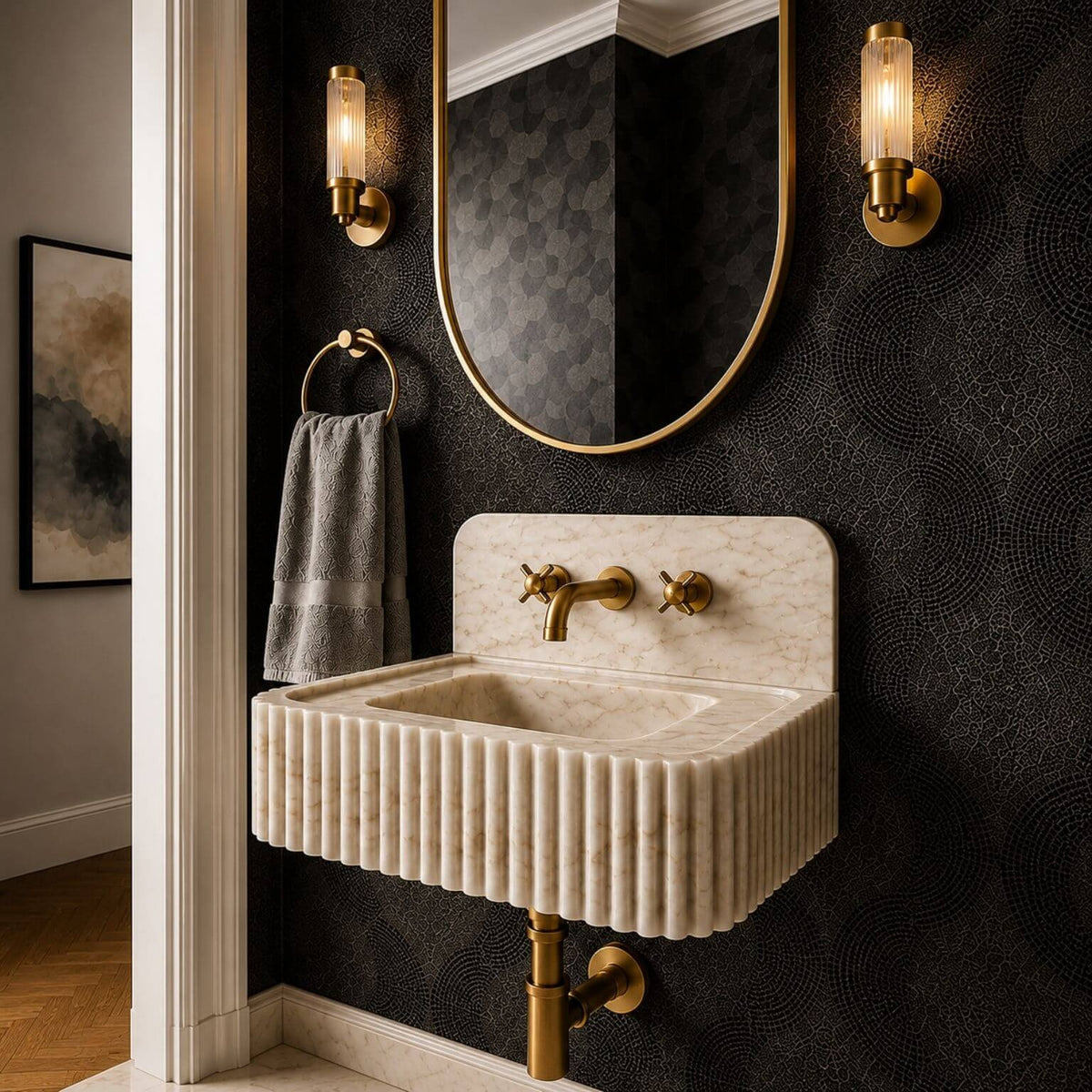 Rectangular Calacatta Gold marble sink with vertical grooves across the front and a smooth white marble top with grey and gold veins.