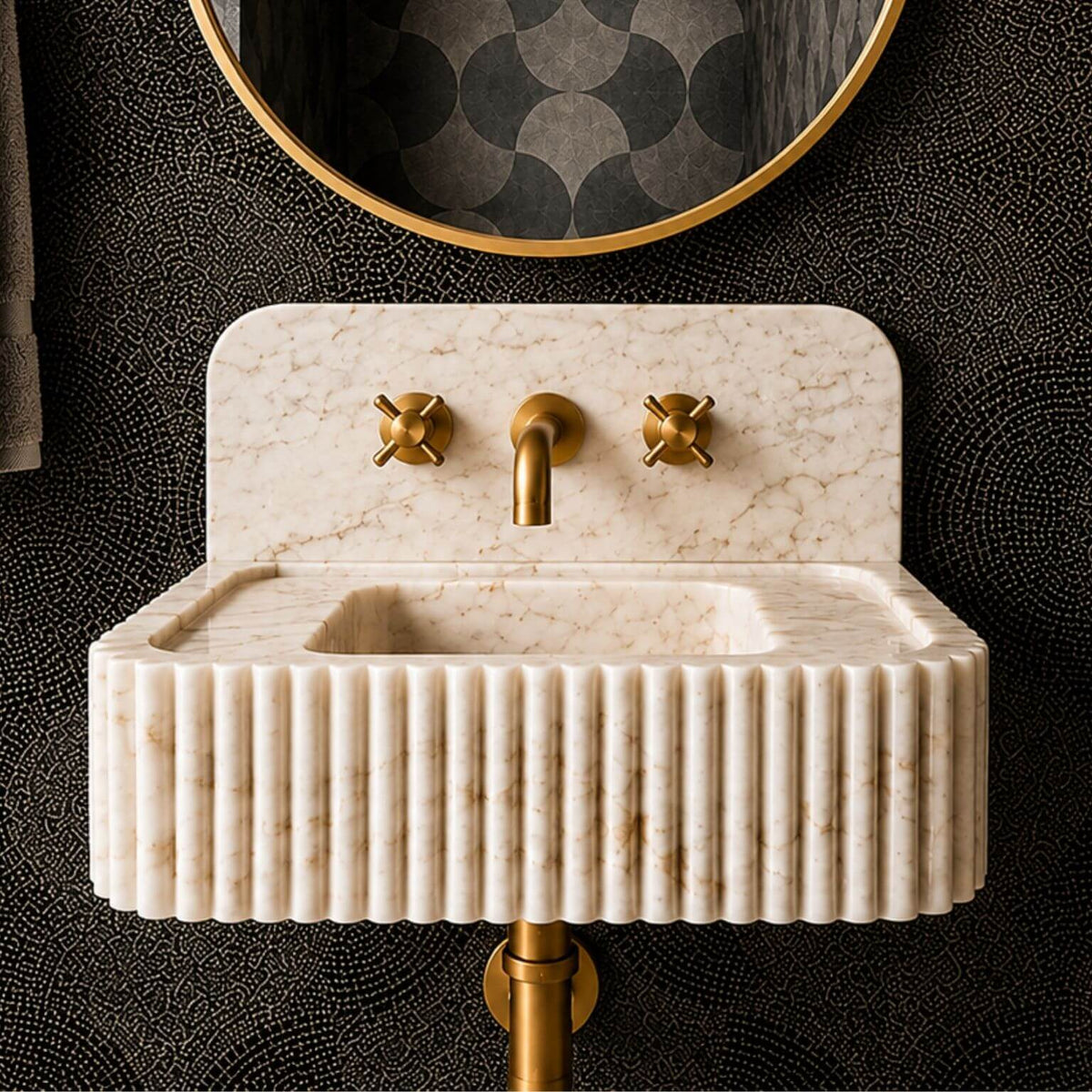 Hand-carved fluted front on a Calacatta Gold marble sink, with natural stone veins visible across both raised and recessed sections.
