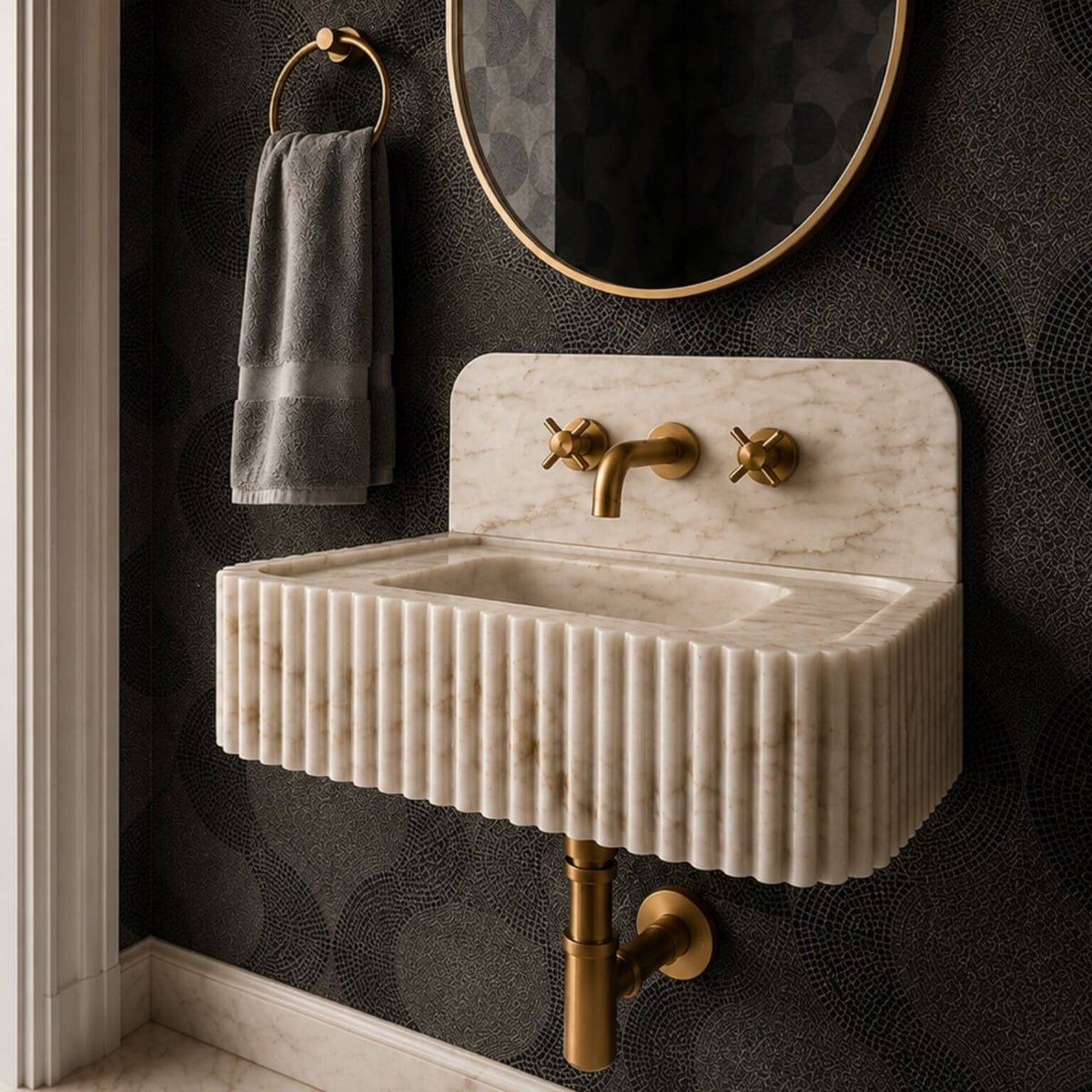 Calacatta Gold marble sink with matching marble backsplash, shown from the front with vertical fluting and natural veining.