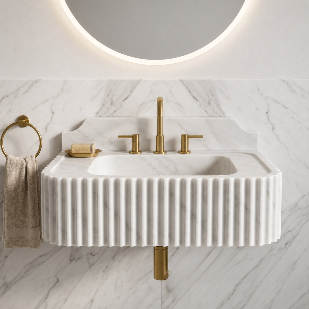 Hand-carved Carrara marble sink with repeated rounded vertical grooves forming a textured front and side surface.