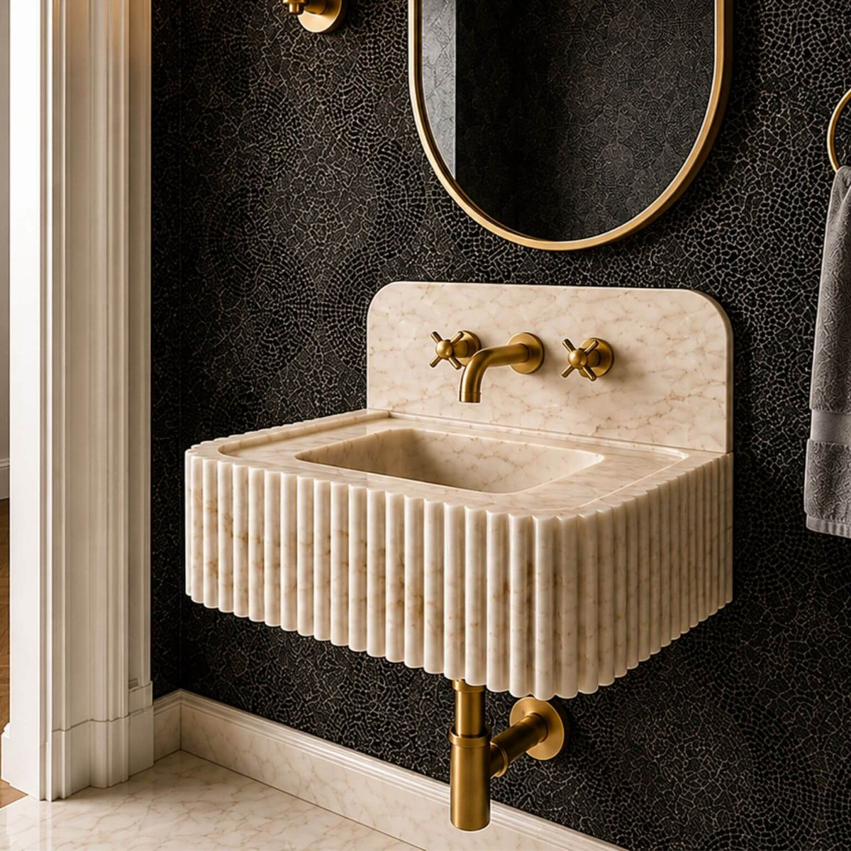 Calacatta Gold marble sink with faucet holes positioned along the rear deck, shown with vertical fluting across the front.