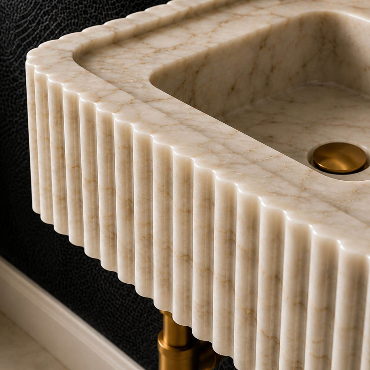 Close view inside a Calacatta Gold marble basin showing the drain opening and natural grey veining continuing through the bowl.