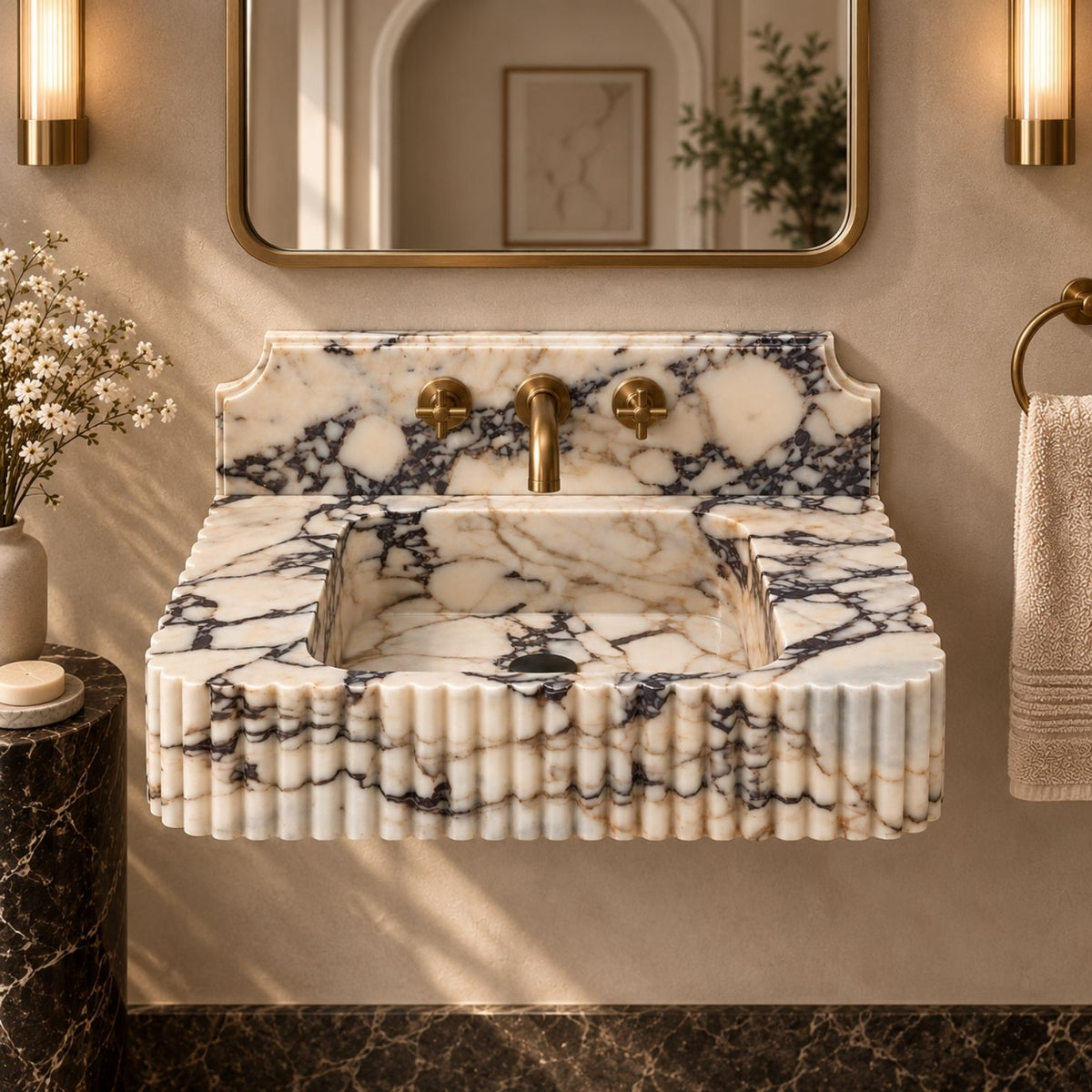 Decorative marble backsplash with three faucet holes above a fluted sink